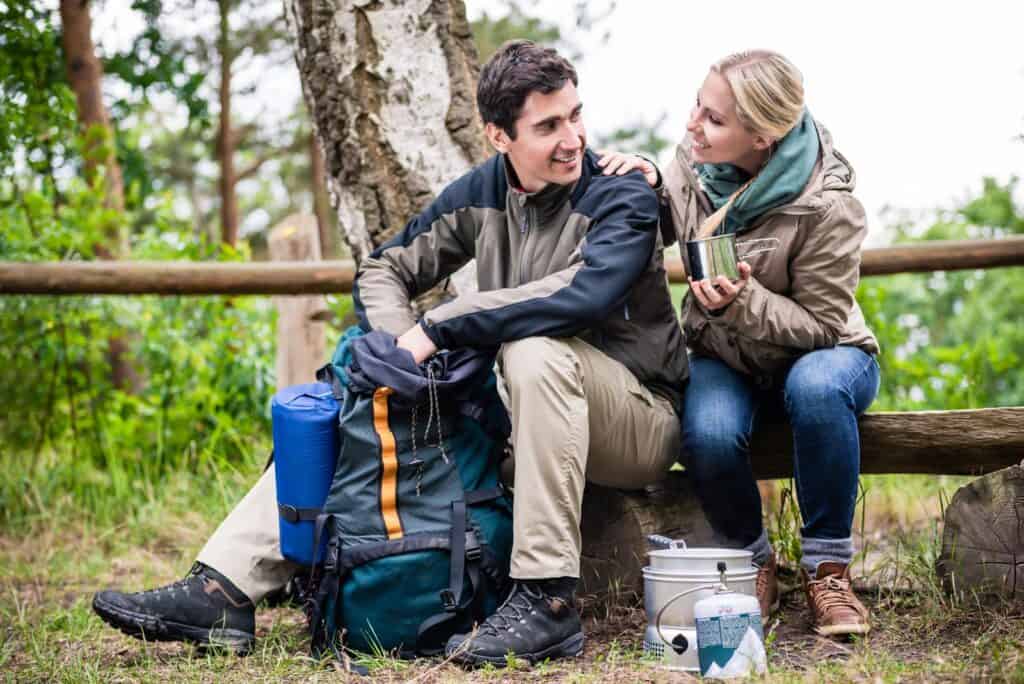 How to Prepare for a Hike and What to Take With You 2 Man and woman taking break from hiking