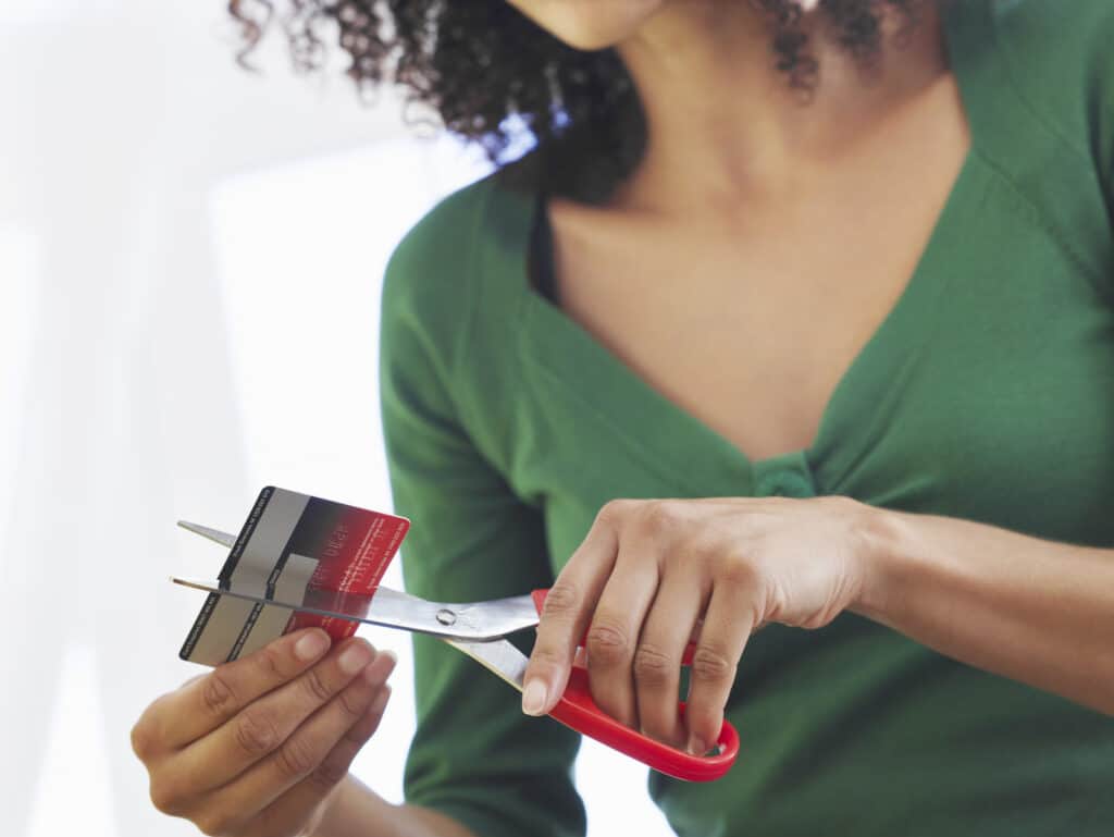 Woman cutting credit card up