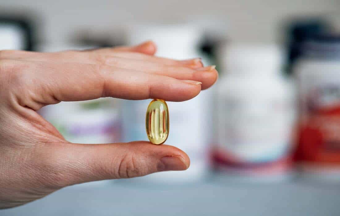 5 Reasons You Should Start Consuming Delta 8 Products 2 Person holding yellow medication pill